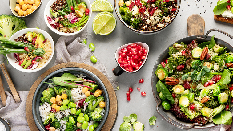 Bunte Sommersalate Bunte Sommersalate mit Gemüse, Quinoa, Kichererbsen, Nüssen und Granatapfelkernen in mehreren Schüsseln